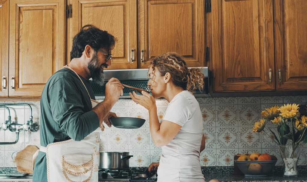 Man and woman tasting food.